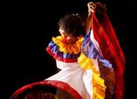 a person in a colourful dress performing a dance